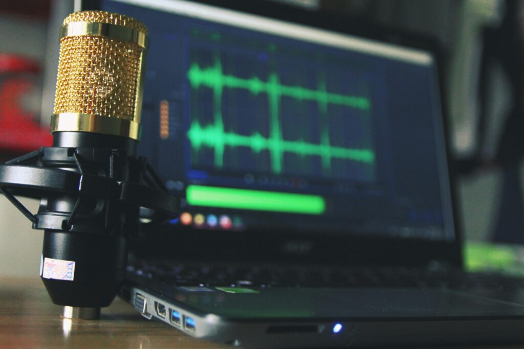 pexels-photo-755416-755416 Close-up of a golden microphone and laptop used for audio editing.